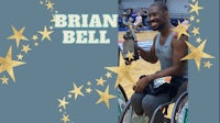 brian bell in a wheelchair holding a trophy