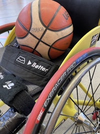 a wheelchair with a ball and a bag